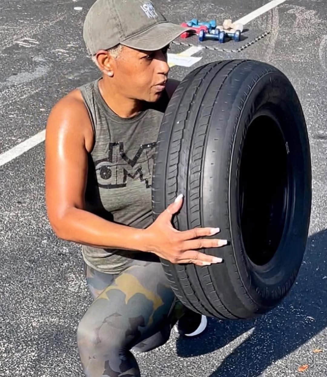 DMP Fitness outdoor boot camp participant training with a tire